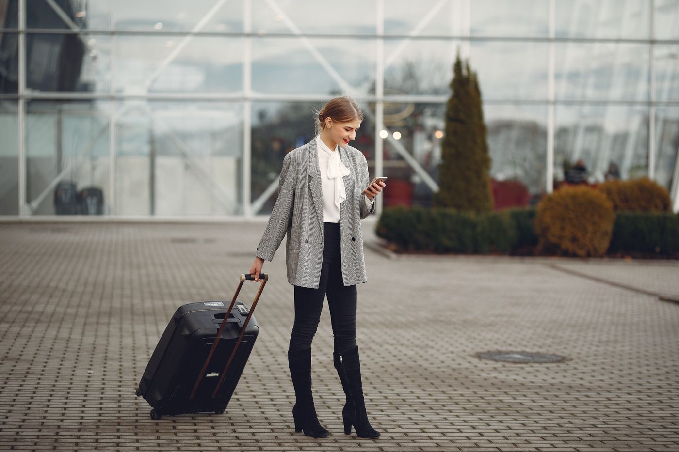 Business traveller waiting outside a modern terminal